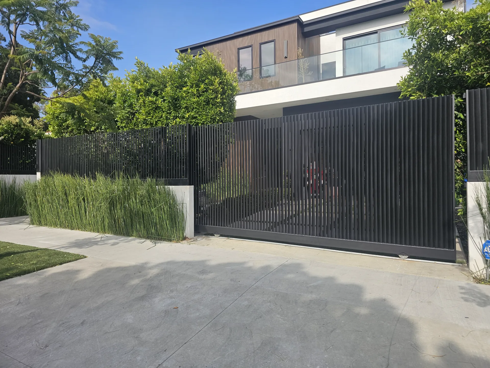 Modern home with a driveway gate — gate repair in Beverly Hills by Silence Garage Door & Gates
