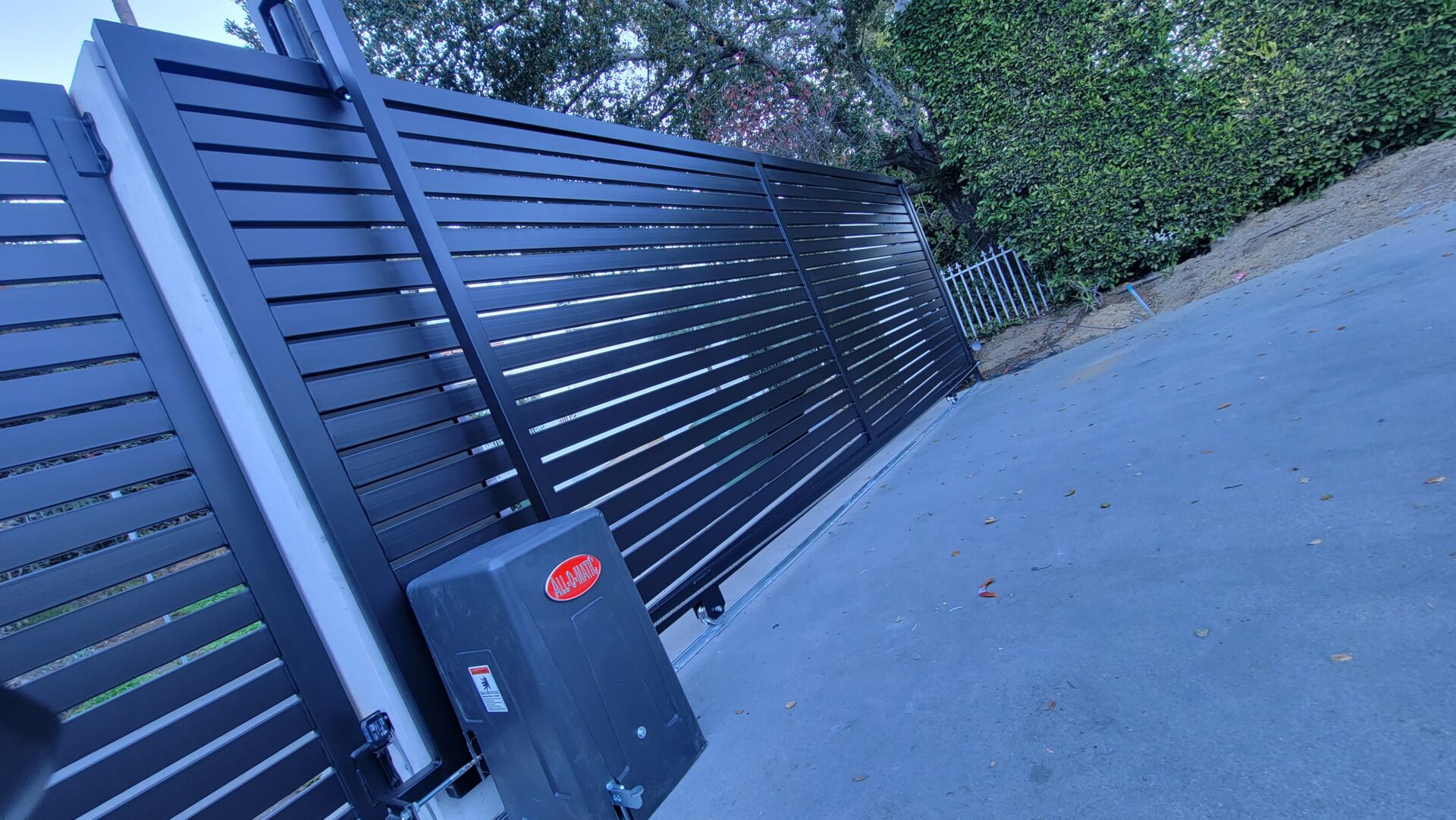 Pasadena. Driveway sliding gate, horizontal slats, All-O-Matic gate motor, intercom system, columns.