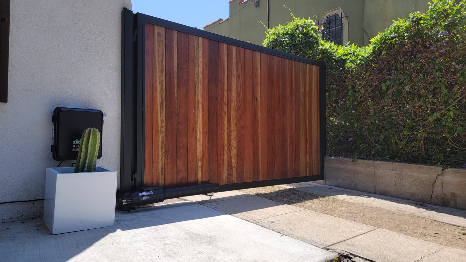 Santa Monica. Swing gate with tongue-and-groove redwood, LiftMaster LA500 gate motor.