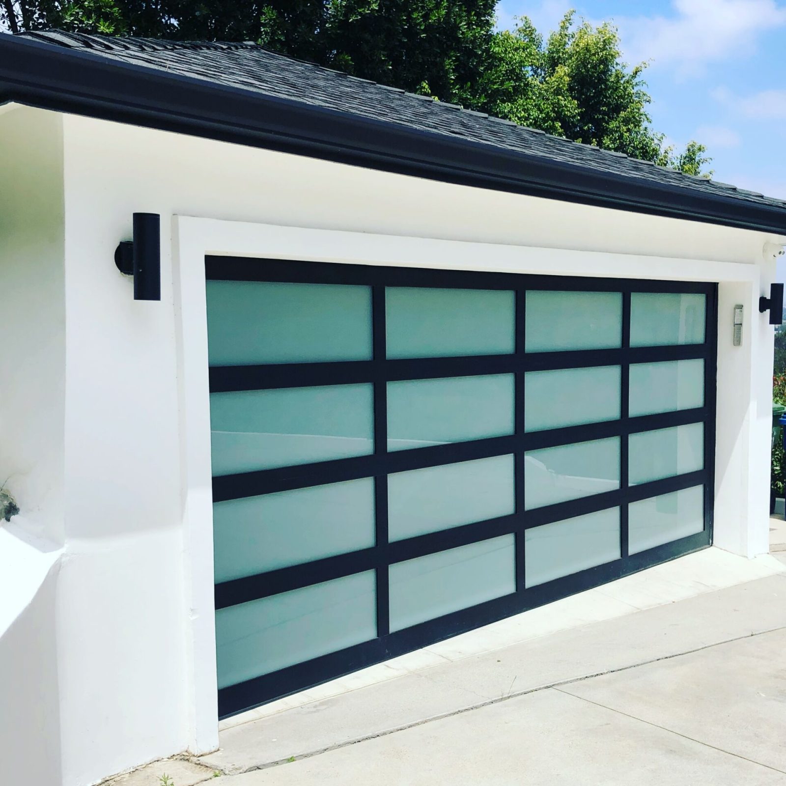 Hollywood Hills. Garage door, full view, laminated glass with aluminum, LiftMaster jackshaft opener.