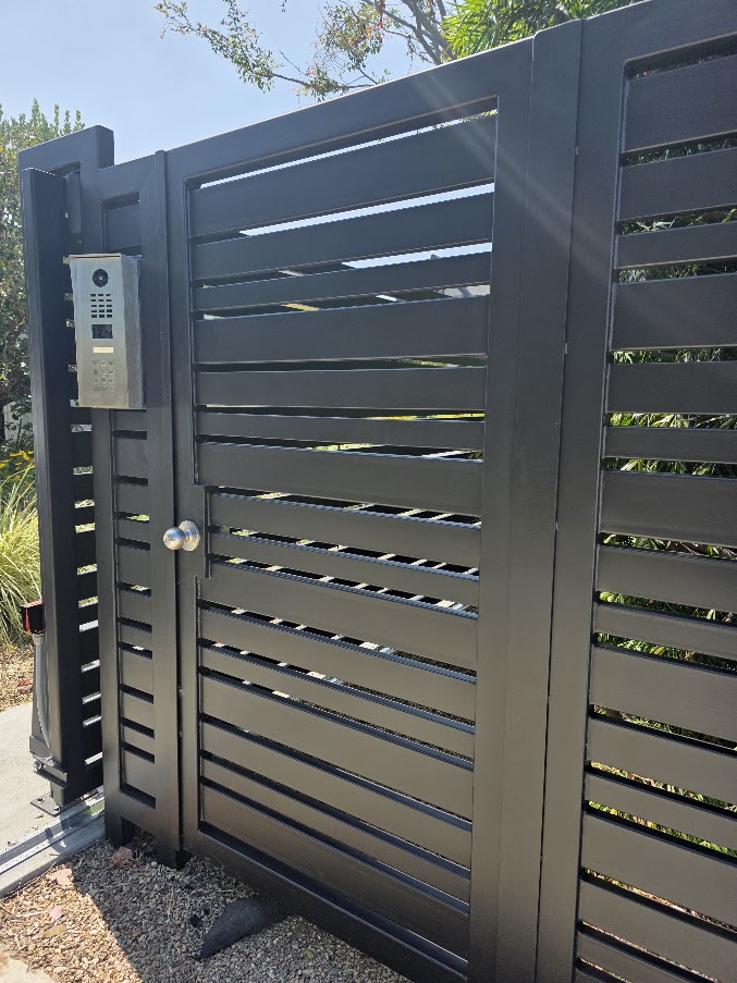 Horizontal-slat pedestrian gate with DoorBird intercom, two fixed panels. Culver City.