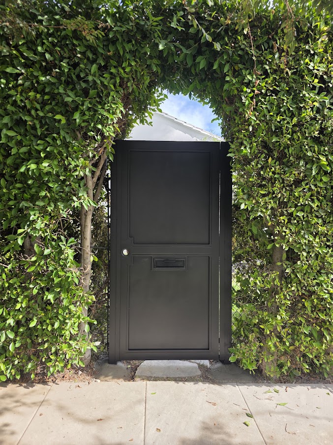 All-metal full-privacy pedestrian gate with built-in mailbox. West Hollywood.