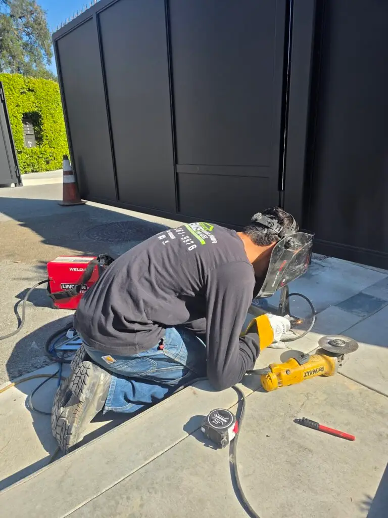 Gate Repair Woodland Hills CA technician repairing electric driveway gate