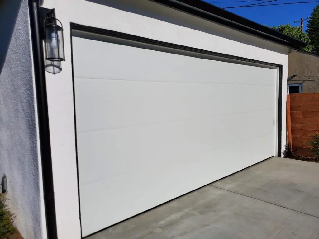 Garage Door Installation showing a modern steel door on a residential home
