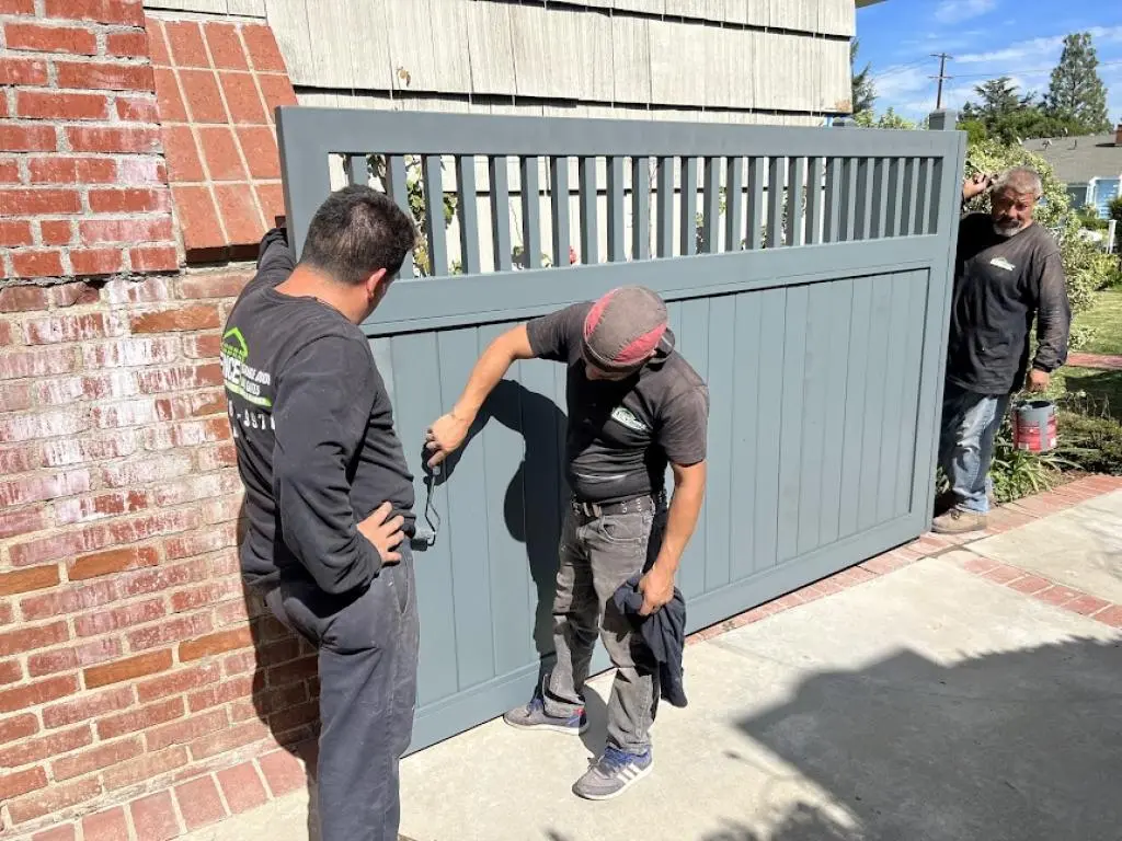 Custom metal driveway gates installed at residential property entrance