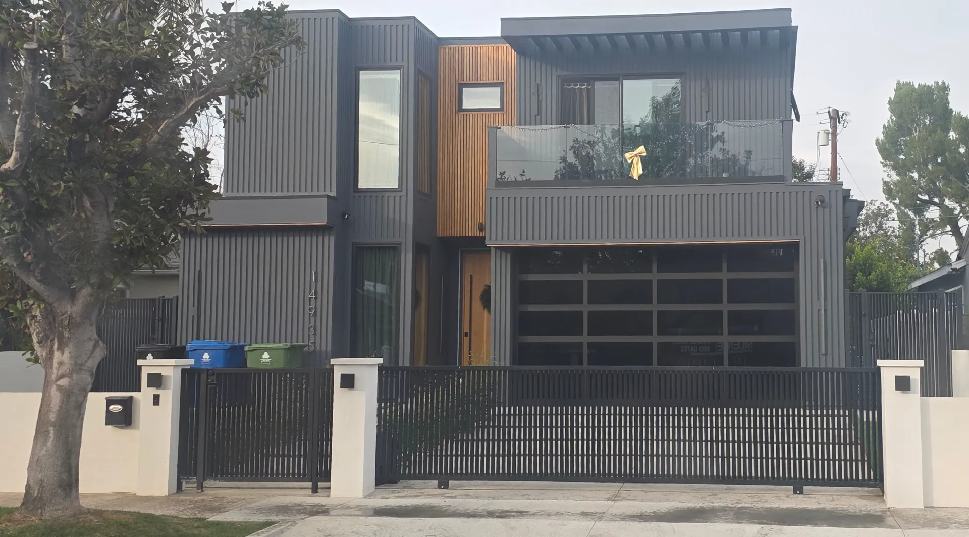Dark slatted driveway gate at a modern Sherman Oaks home